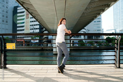 Japanese Girl poses on the street in Yokohama, Japan. Yokohama is a port city located in a bit south of Tokyo.