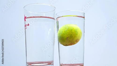 Lemonade falling down into the glass in slow motion photo