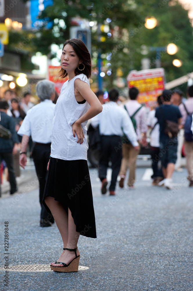 Japanese Girl poses on the street in Yokohama, Japan. Yokohama is a port city located in a bit south of Tokyo.