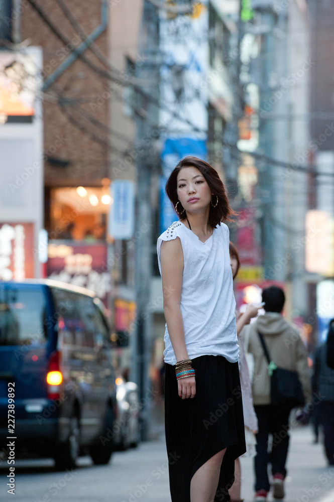 Japanese Girl poses on the street in Yokohama, Japan. Yokohama is a port city located in a bit south of Tokyo. Japanese Girl poses on the street in Yokohama, Japan. Yokohama is a port city located in a bit south of Tokyo.