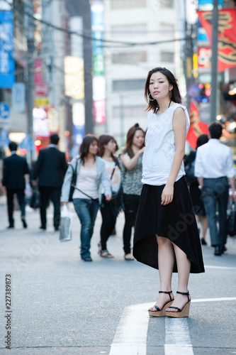 Japanese Girl poses on the street in Yokohama, Japan. Yokohama is a port city located in a bit south of Tokyo.