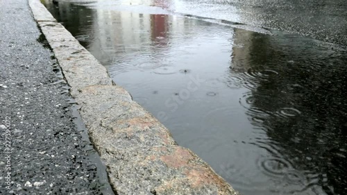 Waterpuddle at the roadside in the rain. photo