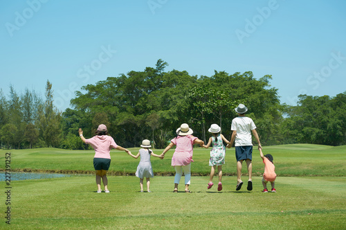 Family jumping together hand in hand  enjoy in the park © jamesteohart