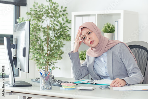 muslim businesswoman have headache while working