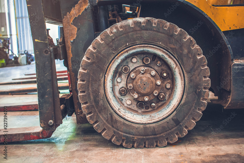 The front wheels of the forklift.