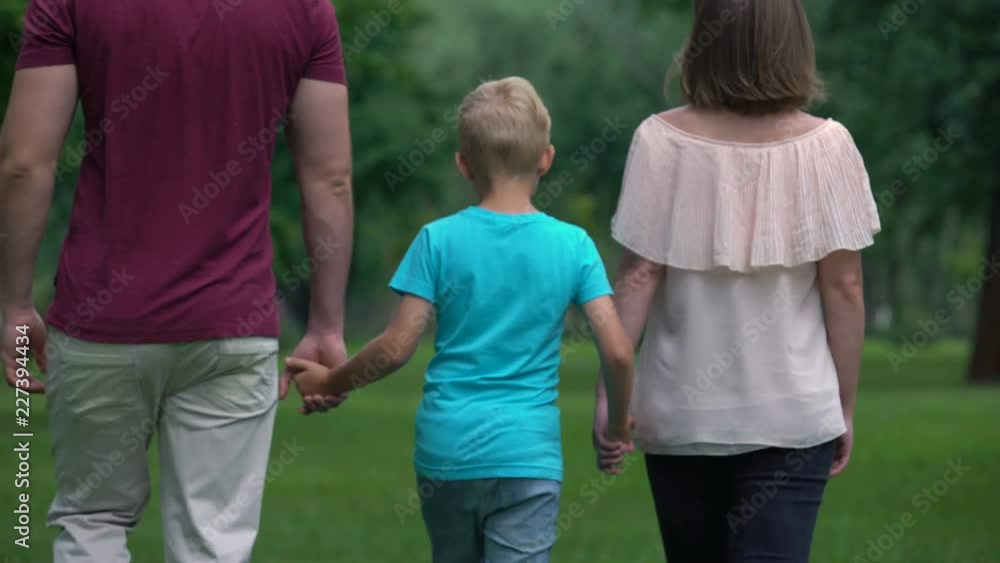Family with kid holding hands, walking away, togetherness and family support Family with kid holding hands, walking away, togetherness and family support