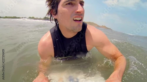 POV: Man Starts to Paddle into Wave photo