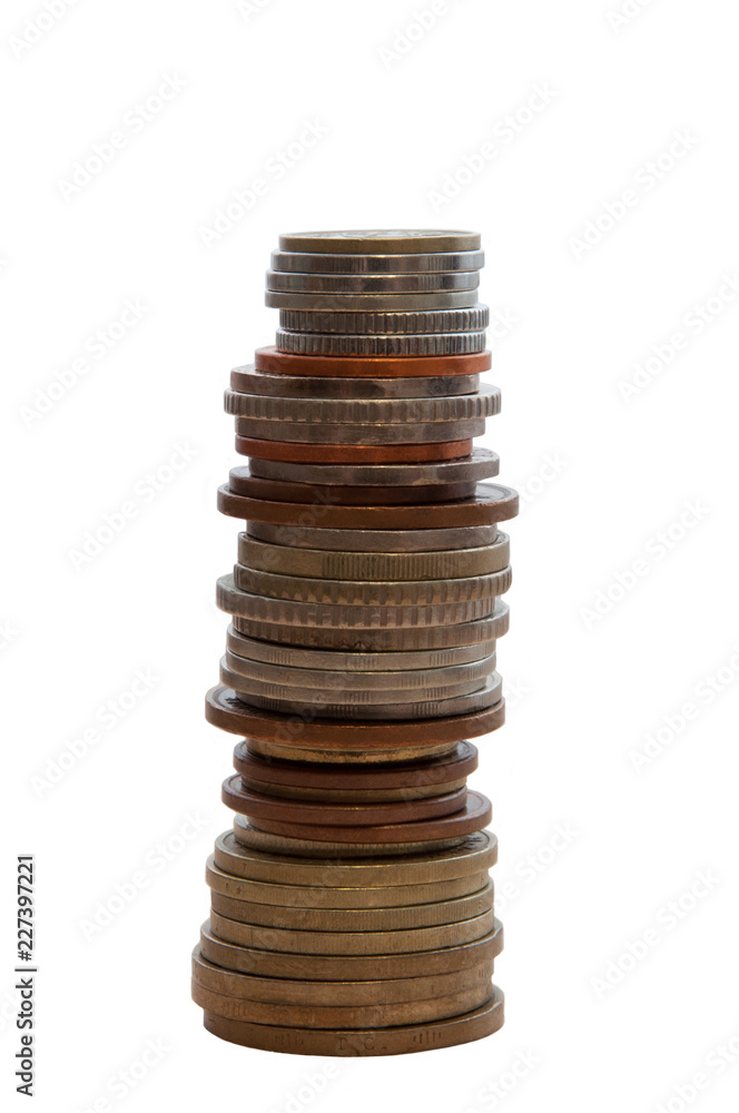 High stack of coins on a white background isolated vertically. High stack of coins on a white background isolated vertically.