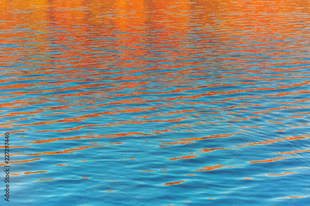 Obraz premium Fall season outdoor background, colorful trees reflect in the water