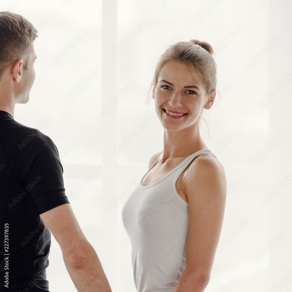 Beautiful smiling sporty woman posing with her boyfriend