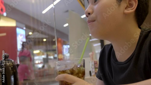Slow motion of Teenager drinking a glass of refreshing cold fizzy cola drink with smile face.