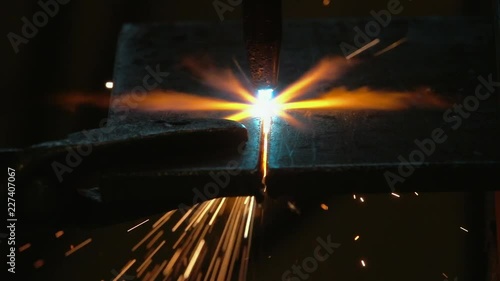 Oxyacetylene cutting through steel, gripping onto steel plate with tool