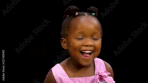 Young black girl making silly faces photo