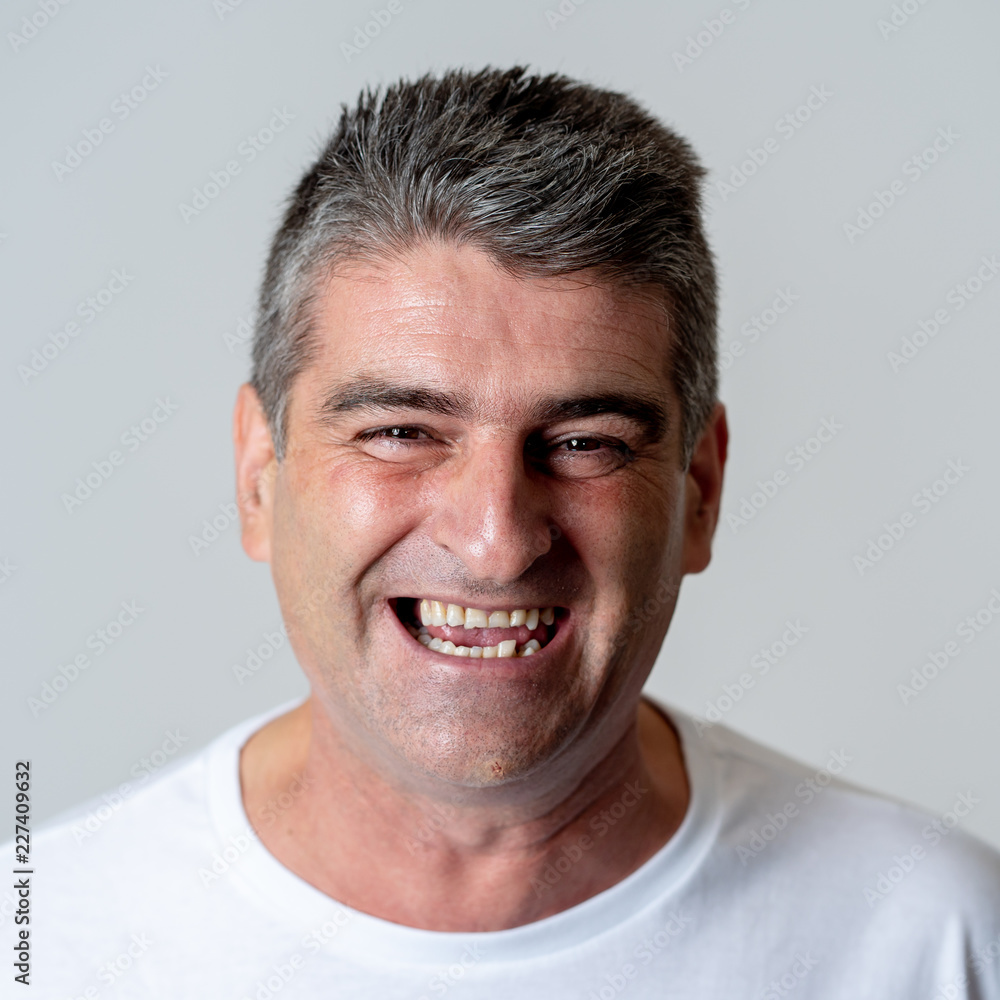 Obraz premium Close up portrait of a smiling and laughing mature man in happy face human emotions and expressions