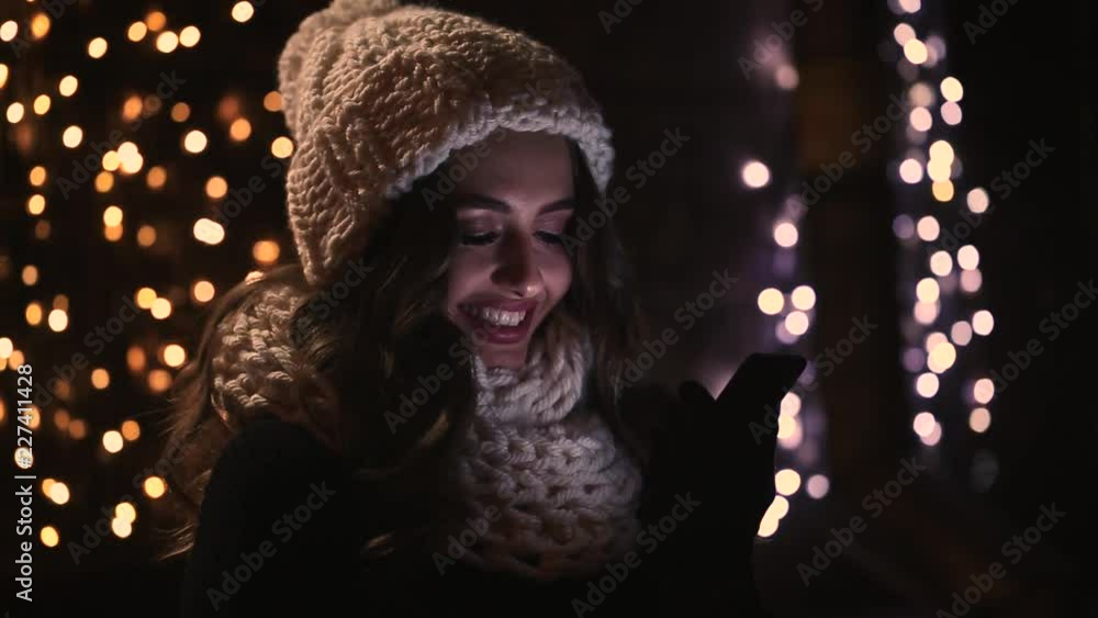 Beautiful girl in the night city with a phone in their hands Beautiful girl in the night city with a phone in their hands