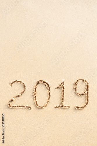 New Year 2019 handwritten on the sandy beach