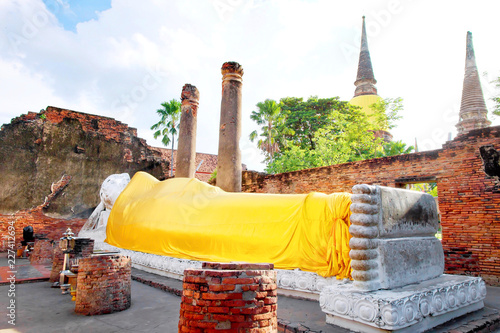 Big white cement buddha statue wearing a yellow coat and pagoda with sunlight at Wat Yai Chaimongkol (Chaimongkhon), Phra Nakhon Si Ayutthaya, Thailand. Beautiful of historic city at buddhism temple photo