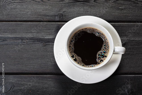 Top view of coffee cup on a wood background