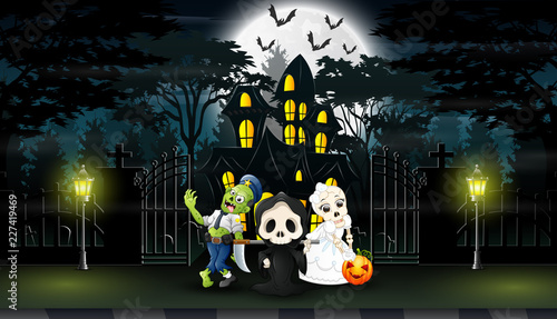 Happy kids wearing halloween costume outdoors with the haunted house background