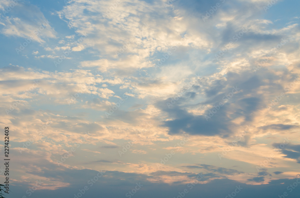 Yellow evening sunset in the sky with clouds