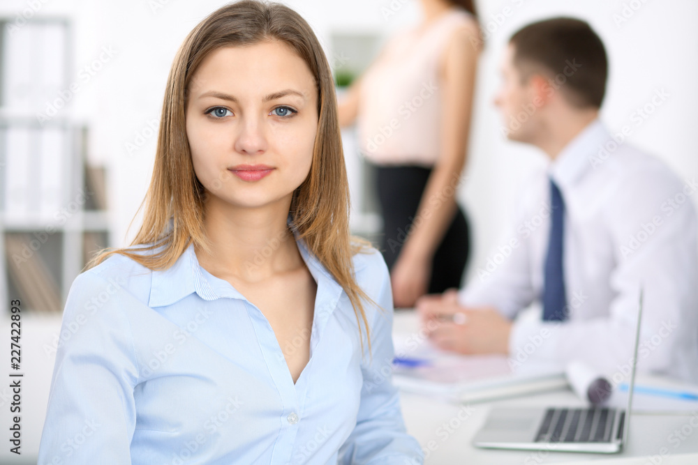Portrait of a young business woman at meeting. Negotiation concept Portrait of a young business woman at meeting. Negotiation concept
