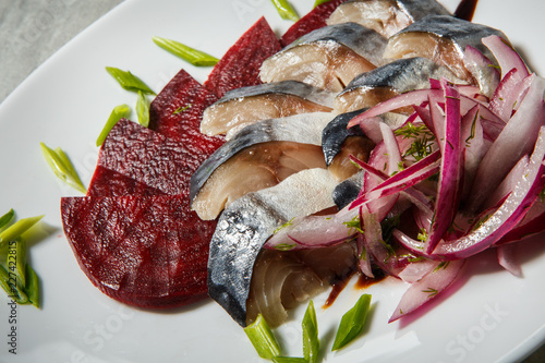 mackerel and beet slices with chopped red and green onion