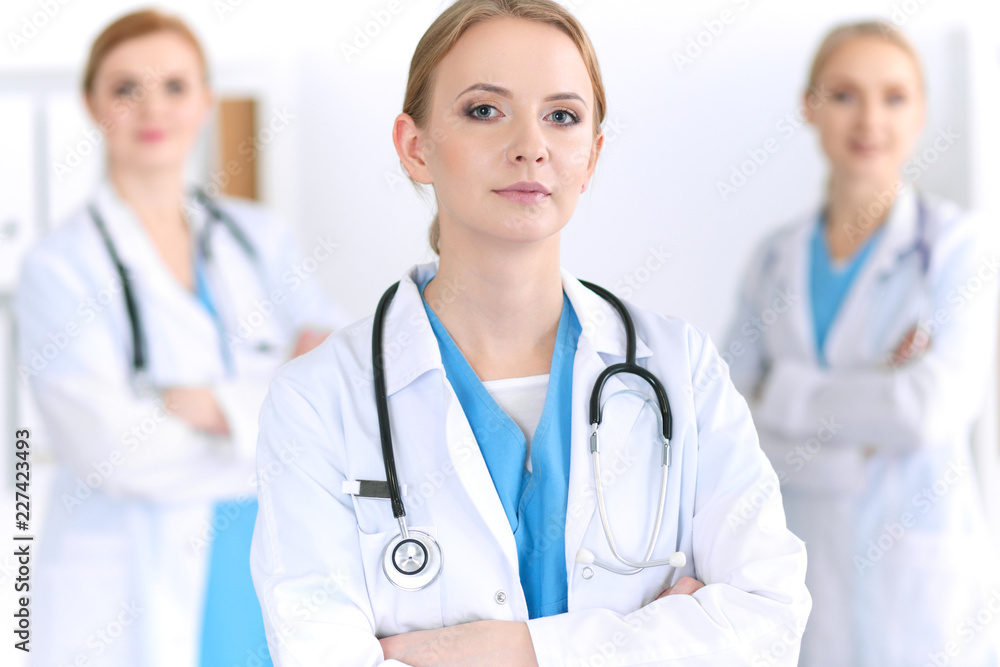 Group of medical doctors standing at hospital. Team of physicians ready to help patients. Medicine and health care concept Group of medical doctors standing at hospital. Team of physicians ready to help patients. Medicine and health care concept