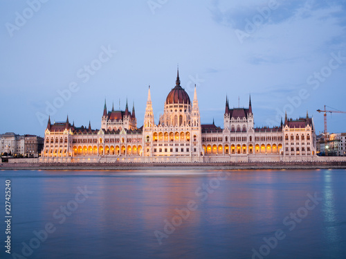 travel and european tourism concept. Budapest, Hungary. Hungarian Parliament Building over Danube River illuminated at night.