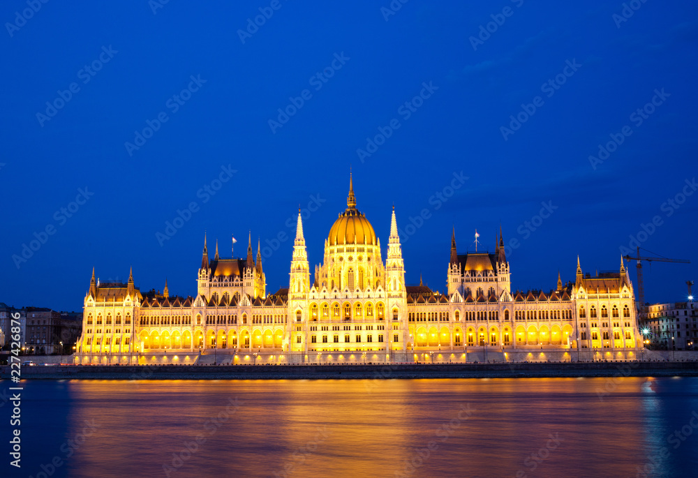 travel and european tourism concept. Budapest, Hungary. Hungarian Parliament Building over Danube River illuminated at night.