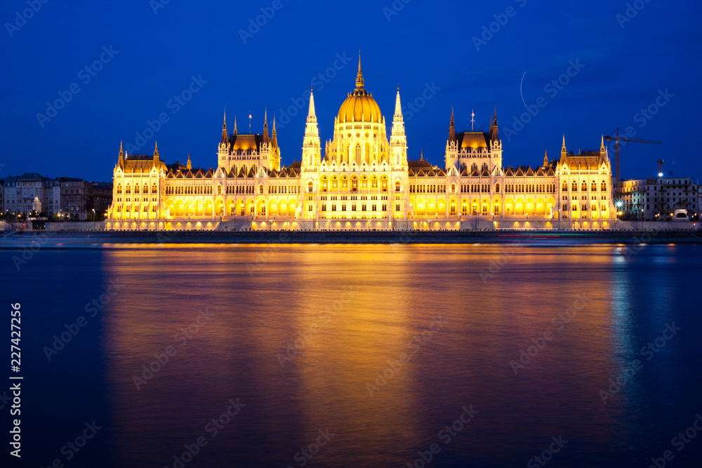 travel and european tourism concept. Budapest, Hungary. Hungarian Parliament Building over Danube River illuminated at night.