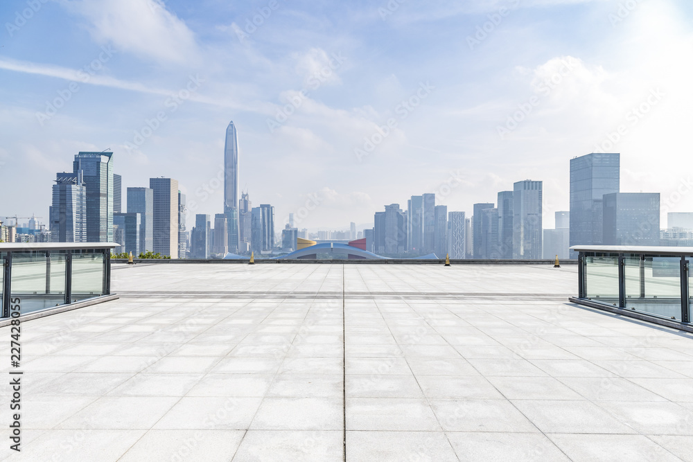 Panoramic skyline and modern business office buildings with empty road,empty concrete square floor Panoramic skyline and modern business office buildings with empty road,empty concrete square floor