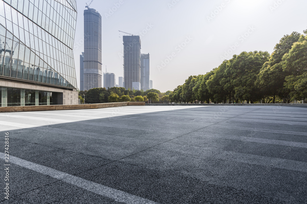 Panoramic skyline and modern business office buildings with empty road,empty concrete square floor Panoramic skyline and modern business office buildings with empty road,empty concrete square floor