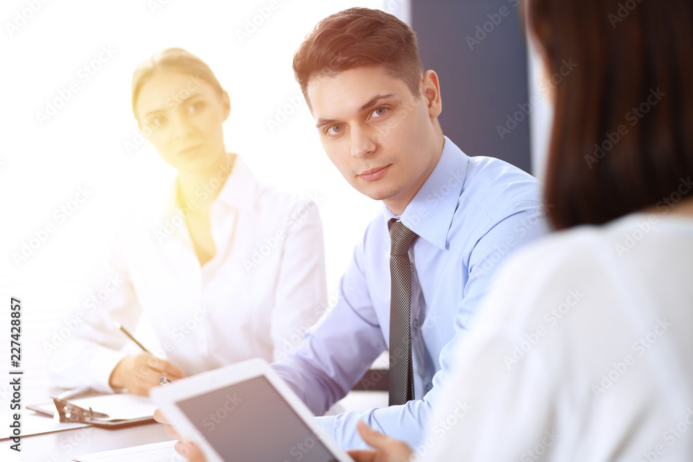 Group of business people or lawyers discussing terms of transaction in office. Meeting and teamwork concept Group of business people or lawyers discussing terms of transaction in office. Meeting and teamwork concept