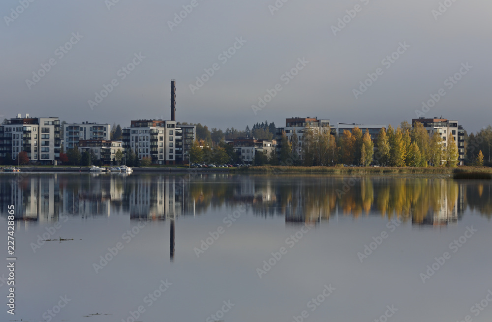 Apartment buildings with colorfull trees by the lake 