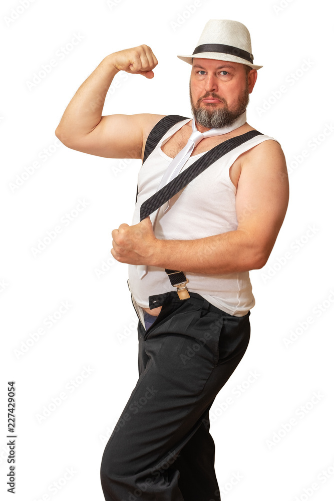 Man in a hat and shirt with a beer belly bent his hand showing his strength. Man in a hat and shirt with a beer belly bent his hand showing his strength.