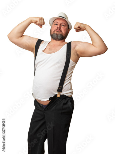 Bild auf Leinwand Man in a hat and shirt with a beer belly bent his hand showing his strength
