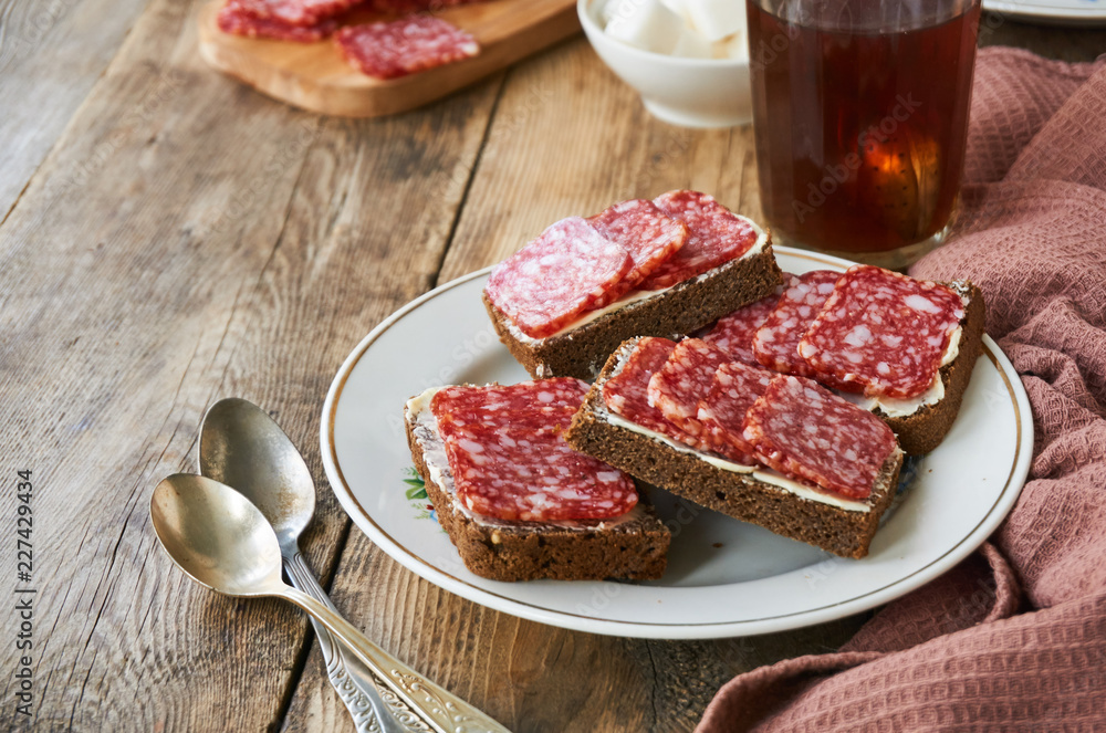 Sandwiches with butter and salami on a plate  