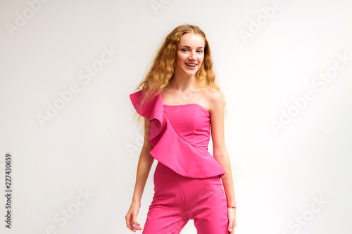 Studio portrait of a beautiful girl blonde teenager on a white background.