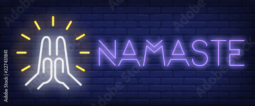 Namaste neon sign. Shining Namaste gesture on brick wall background. Vector illustration in neon style for meditation and spiritual practices