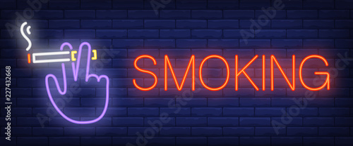 Smoking neon sign. Hand holding smoking cigarette on brick wall background. Vector illustration in neon style for harmful habit and smoking room