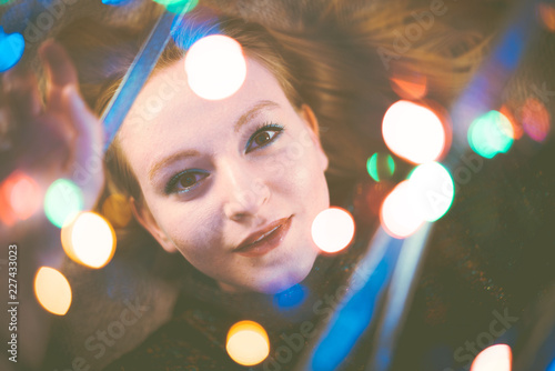portrait of young woman with multicoloured lights