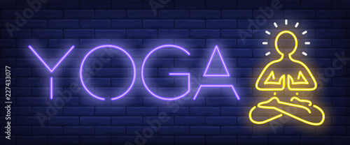 Yoga neon sign. Meditating person on brick wall background. Vector illustration in neon style for meditation and harmony