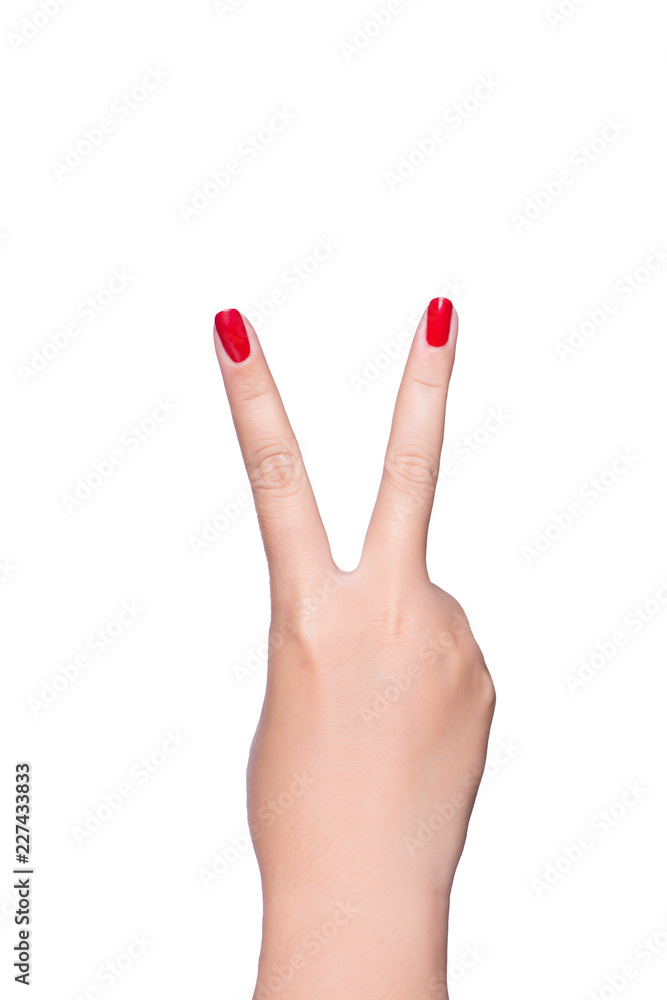 Female hand showing the gesture with two fingers is isolated on white background Female hand showing the gesture with two fingers is isolated on white background