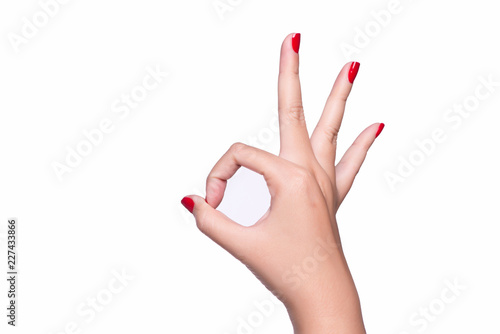 Female hand showing the gesture with ok sign is isolated on white background