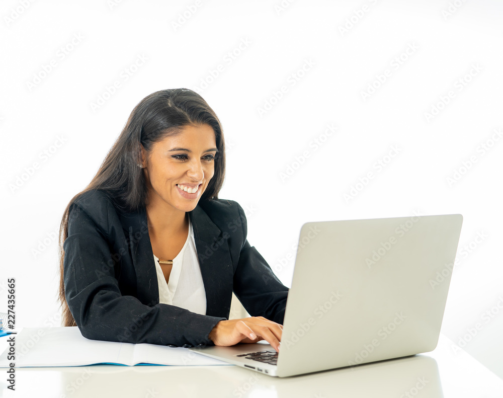 Portrait of attractive young businesswoman working on her laptop looking happy and confident Portrait of attractive young businesswoman working on her laptop looking happy and confident