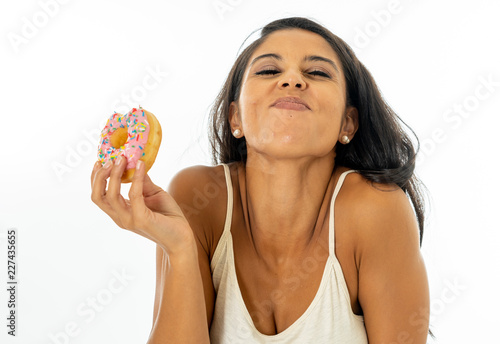 Portrait of attractive pretty girl eating tasty donuts isolated over white background