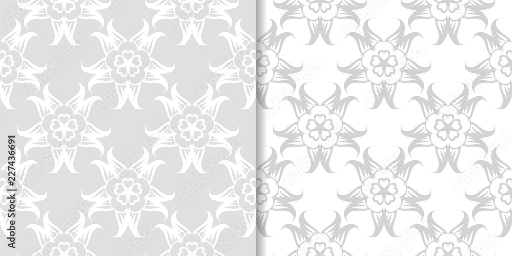 Light gray floral ornamental designs. Set of seamless patterns Light gray floral ornamental designs. Set of seamless patterns