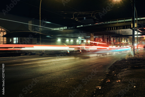 Berlin Karlshorst East living night party lights car red street train asphalt station public transport autumn © julian