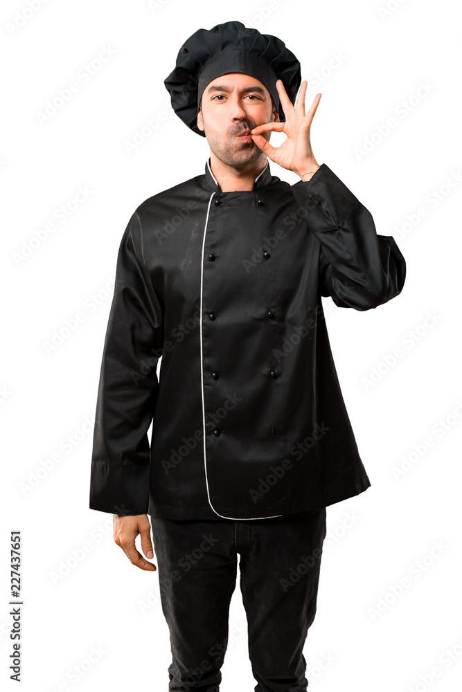 Chef man In black uniform showing a sign of closing mouth and silence gesture doing like closing his mouth with a zipper on isolated white background Chef man In black uniform showing a sign of closing mouth and silence gesture doing like closing his mouth with a zipper on isolated white background