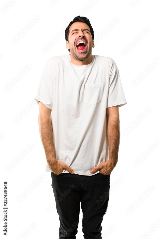 Fototapeta premium Young man with white shirt shouting to the front with mouth wide open on isolated white background